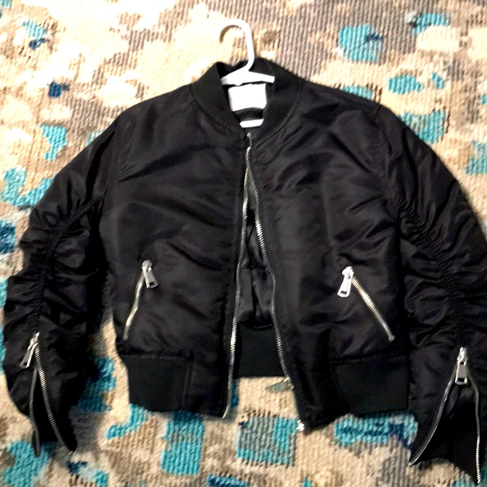 Gorgeous black zip down jacket with rouged sleeves and zippers down sleeves